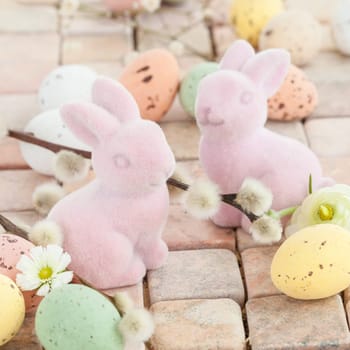 Little pink Easter bunnies and colorful Easter eggs