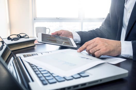 Business, office concept. Working process, Man using digital tablet with financial document.