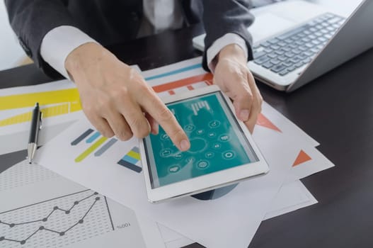 Business, office concept. businessman working with digital tablet and laptop with financial business document.