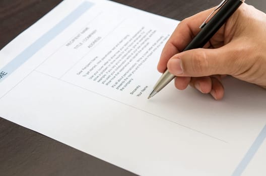 Close-up Businessman or job seeker signing on resume form.