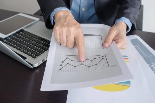 Business, office concept. businessman working with digital tablet and laptop with financial business document.