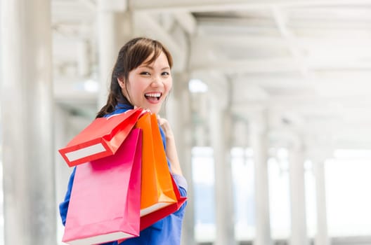 Beautiful young asia woman with shopping bags. Happiness, consumerism, sale concept.