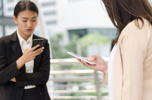 Digital lifesyle concept. Close-up young businesswomen's using smart phone.