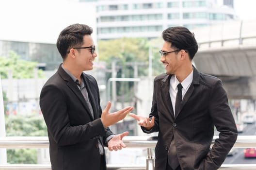 Two businessman discussing with new project at business walk way area in the city. business concepts.