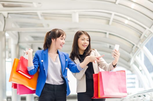Happy shopping asia women with shopping bags walking at the mall.