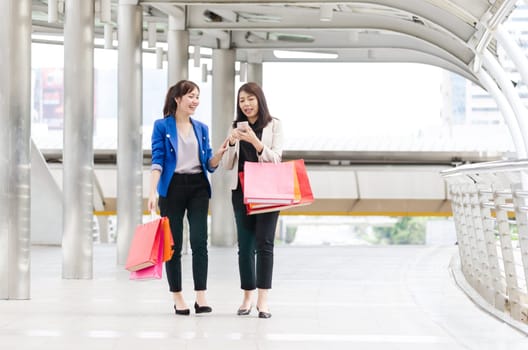 Happy shopping asia women with shopping bags walking at the mall.