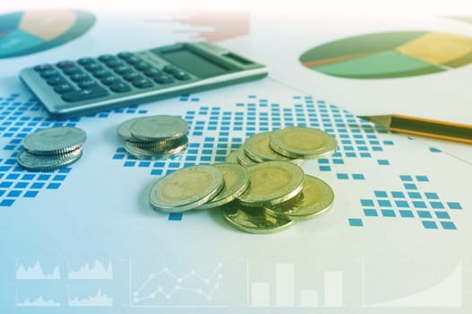 Coin stacks, calculator and pencil on paper of financial graph. Business concept. Color filter.