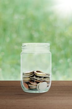 money in the glass. save money for investment concept.