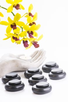 Spa concept with hot stones and tea light close up