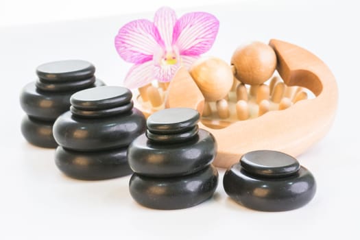 Spa therapy with hot stones, massage roller and cellulite massager close up