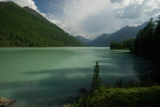 Beautiful mountain landscape near the lake. Mountain Lake. Kind of mountainous terrain and the water in the valley.