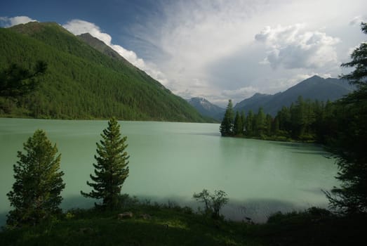 Beautiful mountain landscape near the lake. Mountain Lake. Kind of mountainous terrain and the water in the valley.