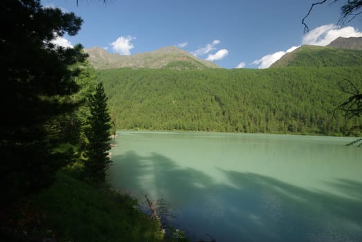 Beautiful mountain landscape near the lake. Mountain Lake. Kind of mountainous terrain and the water in the valley.