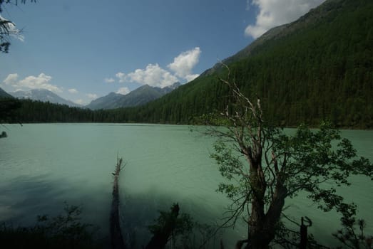 Beautiful mountain landscape near the lake. Mountain Lake. Kind of mountainous terrain and the water in the valley.