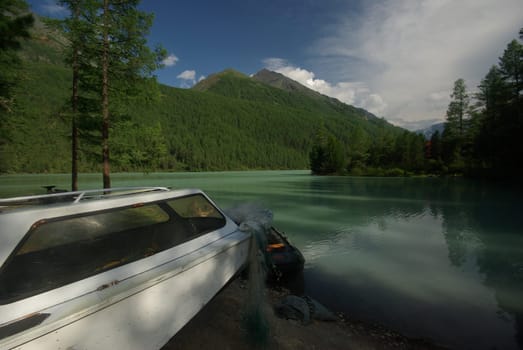 Beautiful mountain landscape near the lake. Mountain Lake. Kind of mountainous terrain and the water in the valley.