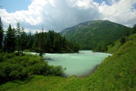 Beautiful mountain landscape near the lake. Mountain Lake. Kind of mountainous terrain and the water in the valley.