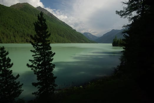 Beautiful mountain landscape near the lake. Mountain Lake. Kind of mountainous terrain and the water in the valley.