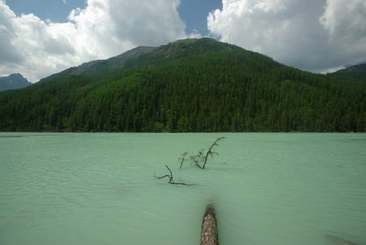 Beautiful mountain landscape near the lake. Mountain Lake. Kind of mountainous terrain and the water in the valley.