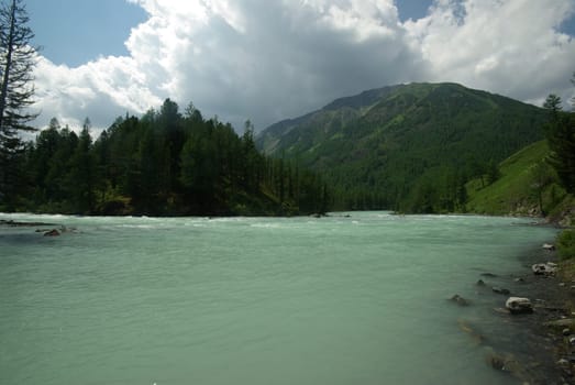 Beautiful mountain landscape near the lake. Mountain Lake. Kind of mountainous terrain and the water in the valley.