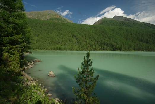 Beautiful mountain landscape near the lake. Mountain Lake. Kind of mountainous terrain and the water in the valley.