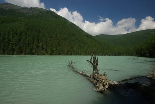 Beautiful mountain landscape near the lake. Mountain Lake. Kind of mountainous terrain and the water in the valley.