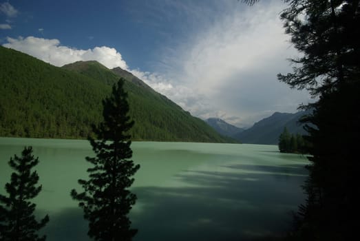 Beautiful mountain landscape near the lake. Mountain Lake. Kind of mountainous terrain and the water in the valley.