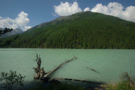 Beautiful mountain landscape near the lake. Mountain Lake. Kind of mountainous terrain and the water in the valley.