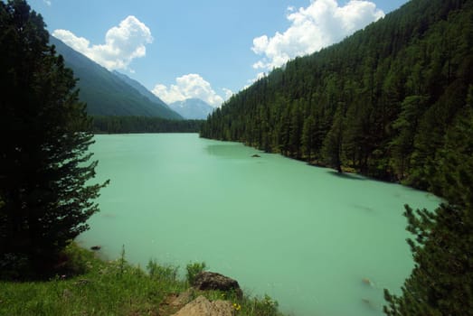 Beautiful mountain landscape near the lake. Mountain Lake. Kind of mountainous terrain and the water in the valley.