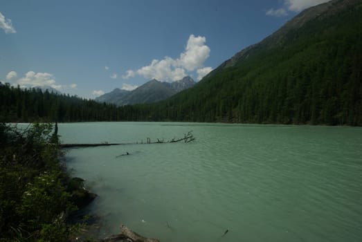 Beautiful mountain landscape near the lake. Mountain Lake. Kind of mountainous terrain and the water in the valley.