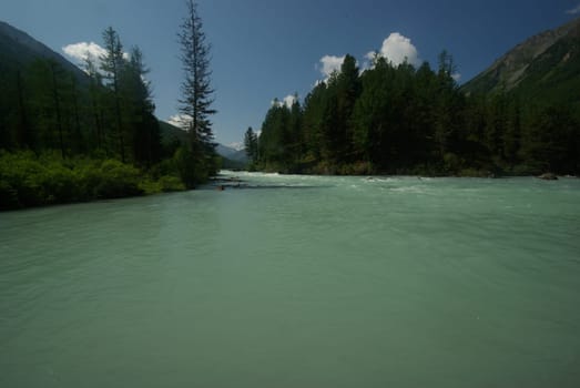Beautiful mountain landscape near the lake. Mountain Lake. Kind of mountainous terrain and the water in the valley.