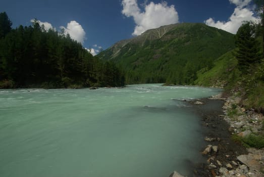 Beautiful mountain landscape near the lake. Mountain Lake. Kind of mountainous terrain and the water in the valley.