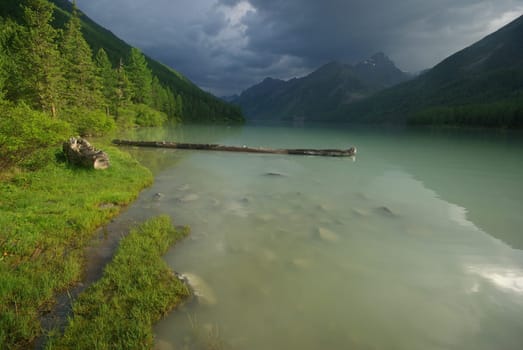 Beautiful mountain landscape near the lake. Mountain Lake. Kind of mountainous terrain and the water in the valley.