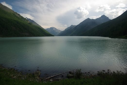Beautiful mountain landscape near the lake. Mountain Lake. Kind of mountainous terrain and the water in the valley.
