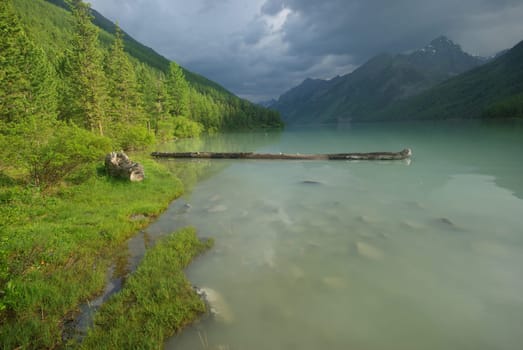 Beautiful mountain landscape near the lake. Mountain Lake. Kind of mountainous terrain and the water in the valley.