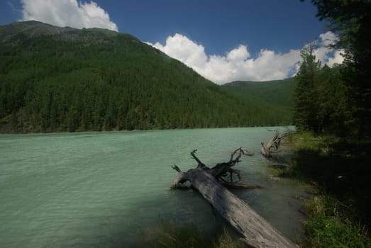 Beautiful mountain landscape near the lake. Mountain Lake. Kind of mountainous terrain and the water in the valley.
