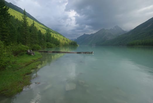 Beautiful mountain landscape near the lake. Mountain Lake. Kind of mountainous terrain and the water in the valley.