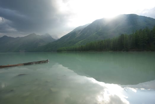Beautiful mountain landscape near the lake. Mountain Lake. Kind of mountainous terrain and the water in the valley.