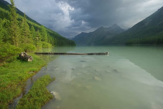 Beautiful mountain landscape near the lake. Mountain Lake. Kind of mountainous terrain and the water in the valley.