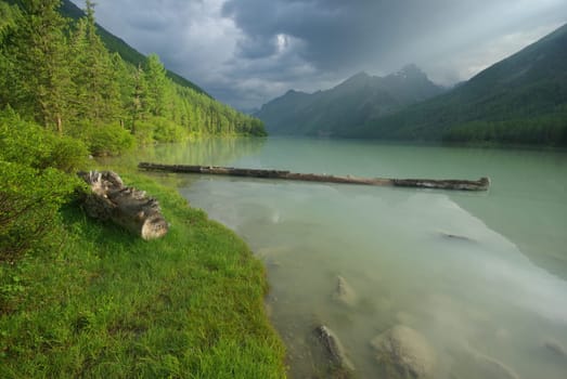 Beautiful mountain landscape near the lake. Mountain Lake. Kind of mountainous terrain and the water in the valley.