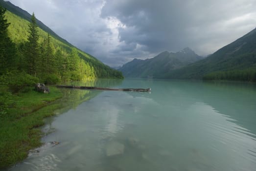 Beautiful mountain landscape near the lake. Mountain Lake. Kind of mountainous terrain and the water in the valley.