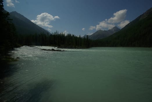 Beautiful mountain landscape near the lake. Mountain Lake. Kind of mountainous terrain and the water in the valley.