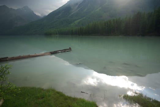 Beautiful mountain landscape near the lake. Mountain Lake. Kind of mountainous terrain and the water in the valley.