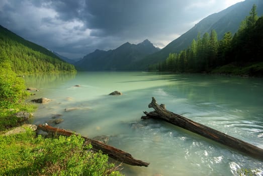 Beautiful mountain landscape near the lake. Mountain Lake. Kind of mountainous terrain and the water in the valley.