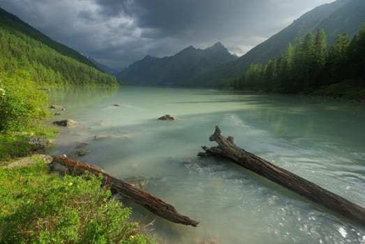 Beautiful mountain landscape near the lake. Mountain Lake. Kind of mountainous terrain and the water in the valley.