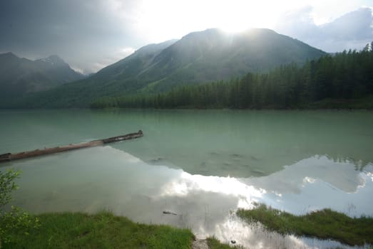 Beautiful mountain landscape near the lake. Mountain Lake. Kind of mountainous terrain and the water in the valley.