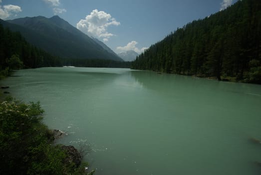 Beautiful mountain landscape near the lake. Mountain Lake. Kind of mountainous terrain and the water in the valley.