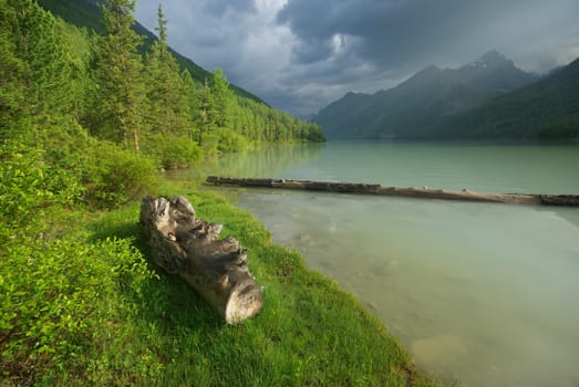 Beautiful mountain landscape near the lake. Mountain Lake. Kind of mountainous terrain and the water in the valley.
