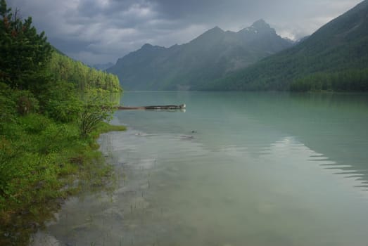 Beautiful mountain landscape near the lake. Mountain Lake. Kind of mountainous terrain and the water in the valley.