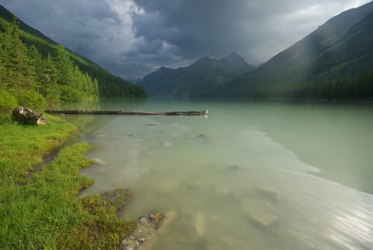 Beautiful mountain landscape near the lake. Mountain Lake. Kind of mountainous terrain and the water in the valley.