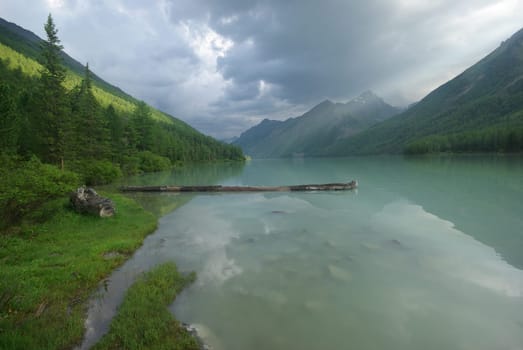 Beautiful mountain landscape near the lake. Mountain Lake. Kind of mountainous terrain and the water in the valley.